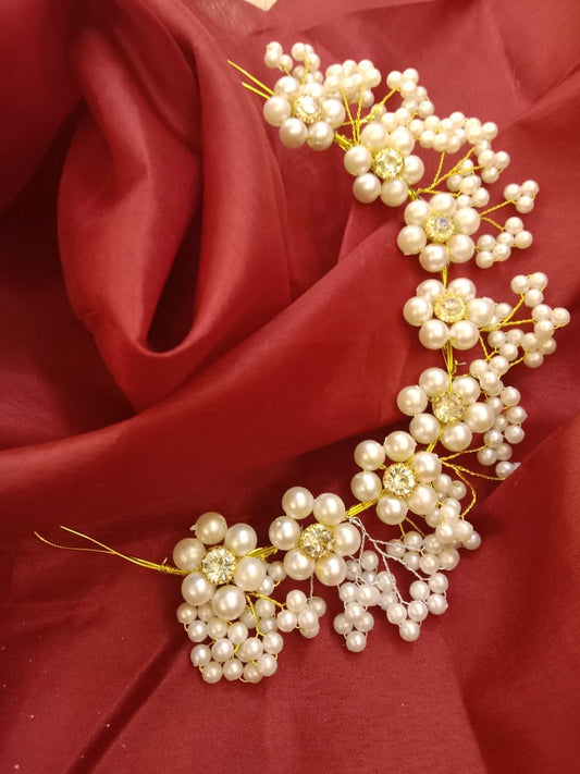 Add a touch of elegance and timeless beauty to your wedding look with our Bridal Pearls Decorative Hair Comb. Expertly crafted with lustrous white pearls, sparkling crystals, and delicate silver wiring, this comb features an intricate floral and leaf design that complements a variety of bridal hairstyles. Whether you're wearing an elegant updo, a romantic half-up style, or flowing curls, this versatile accessory adds the perfect finishing touch. Lightweight and easy to secure, it ensures comfort throughout 