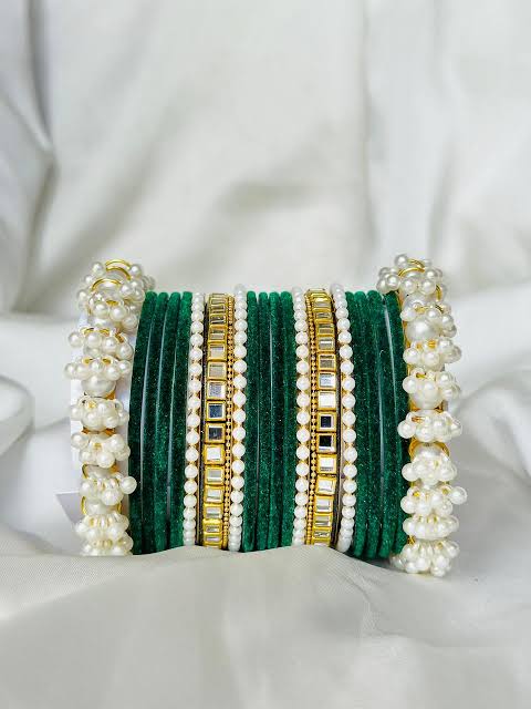 "Elegant Pearl Velvet Bangle Set featuring soft velvet texture, adorned with shimmering pearls and golden accents. A perfect blend of traditional and modern design, ideal for weddings, festive occasions, and special events."