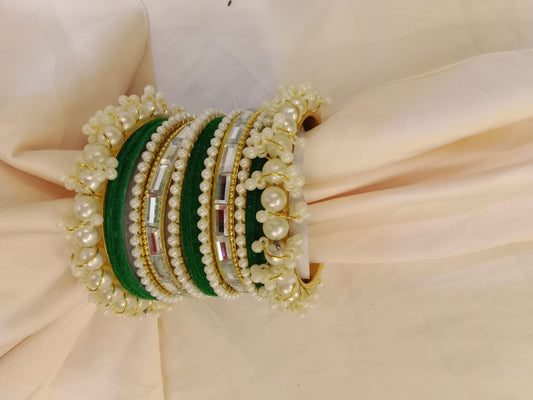 "Elegant Pearl Velvet Bangle Set featuring soft velvet texture, adorned with shimmering pearls and golden accents. A perfect blend of traditional and modern design, ideal for weddings, festive occasions, and special events."